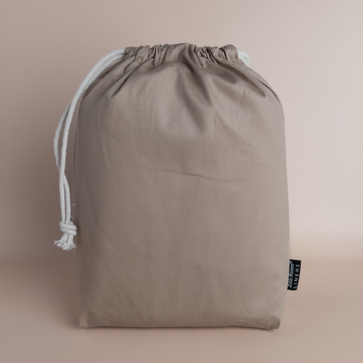 Little Human Linens Mocha european cot waterproof fitted sheet in branded reusable packaging bag