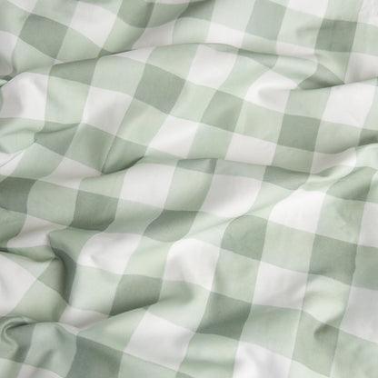 Close-up of green gingham organic cotton waterproof fabric used in Little Human Linens fitted sheet, showing soft textured weave