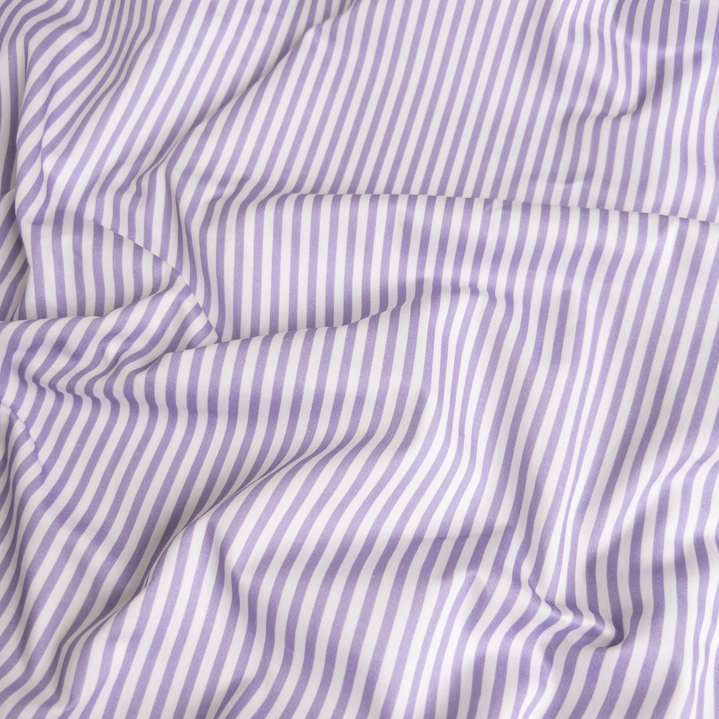 Close-up of lavender stripe organic cotton waterproof fabric used in Little Human Linens fitted sheet, showing soft textured weave