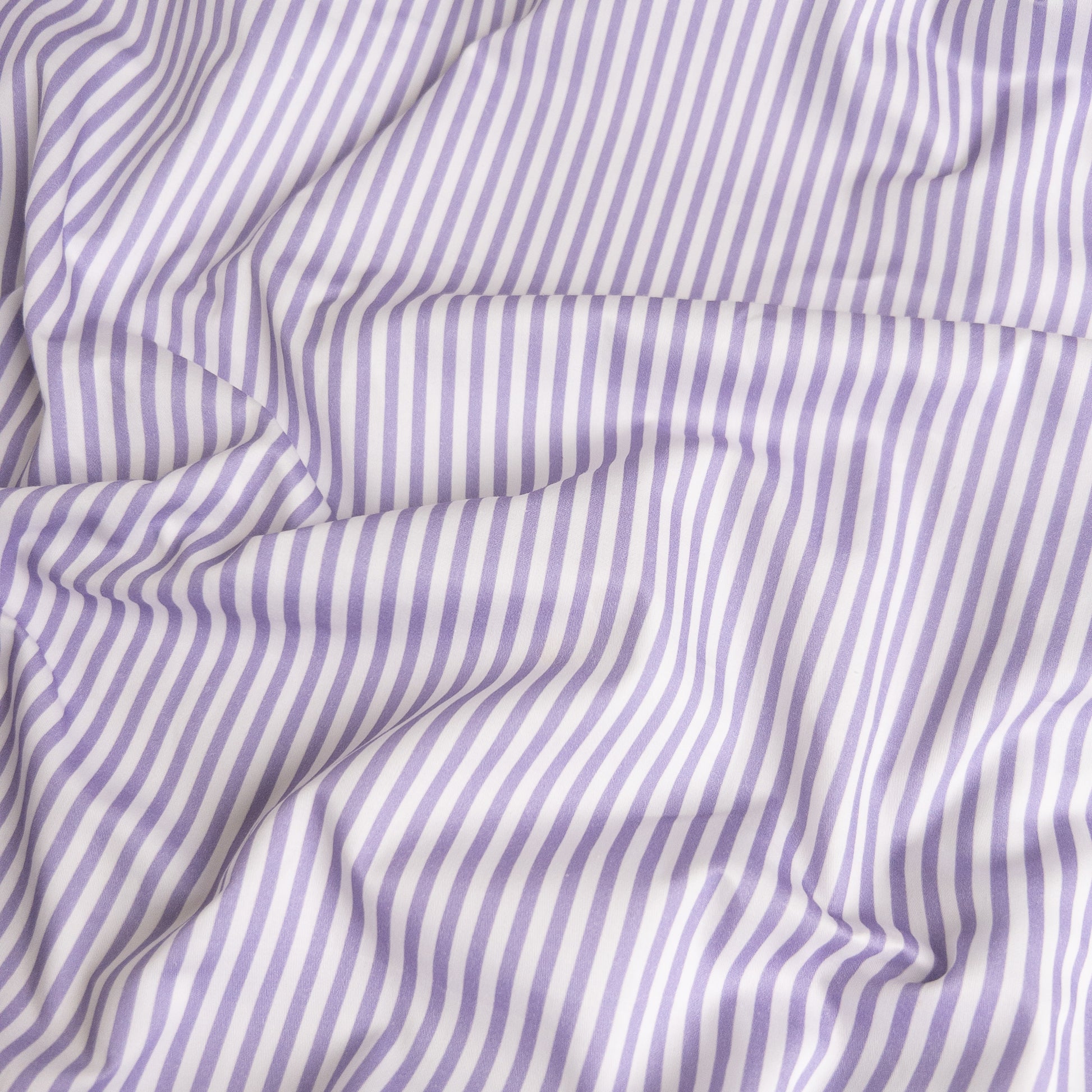 Close-up of lavender stripe organic cotton waterproof fabric used in Little Human Linens fitted sheet, showing soft textured weave