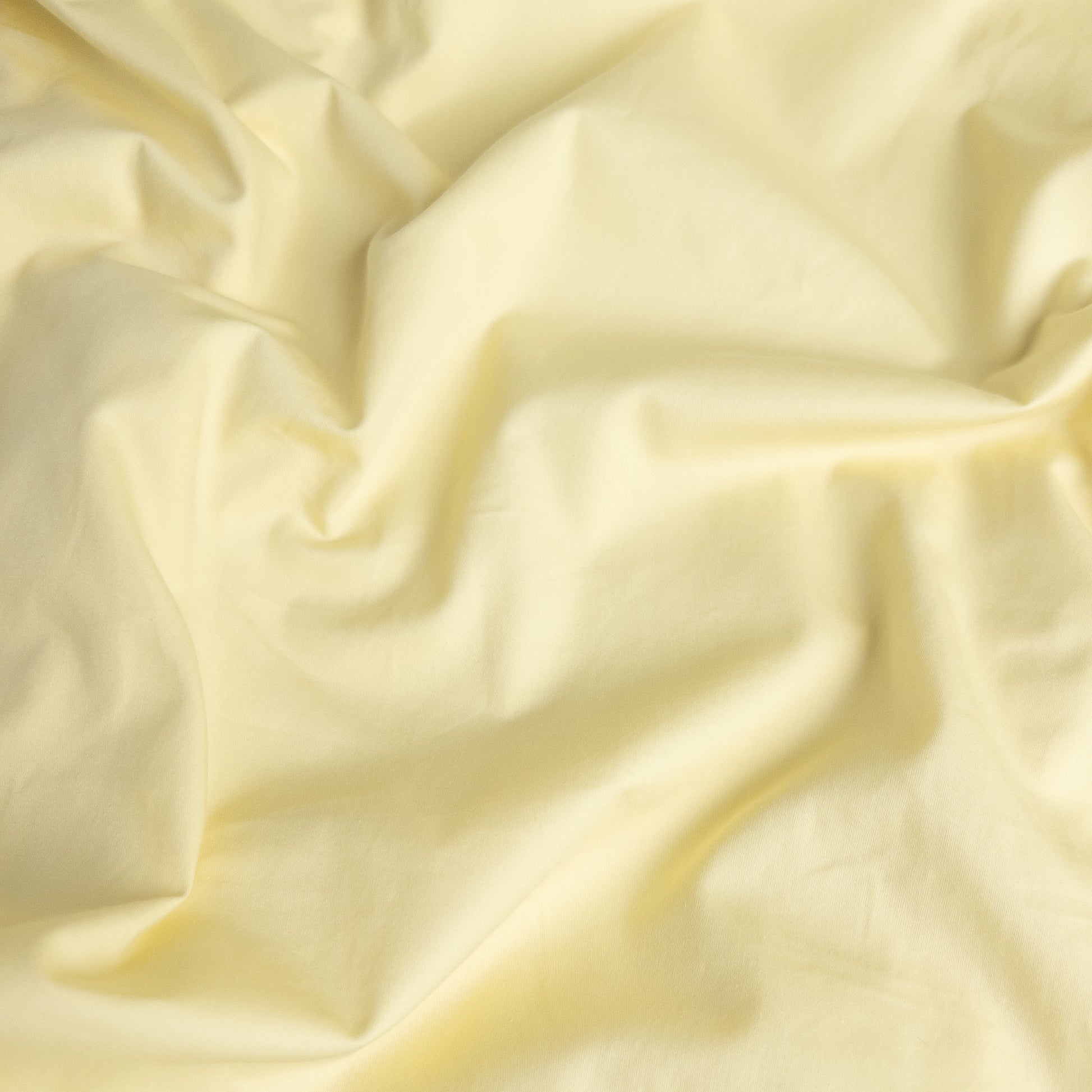Close-up of limoncello organic cotton waterproof fabric used in Little Human Linens fitted sheet, showing soft textured weave