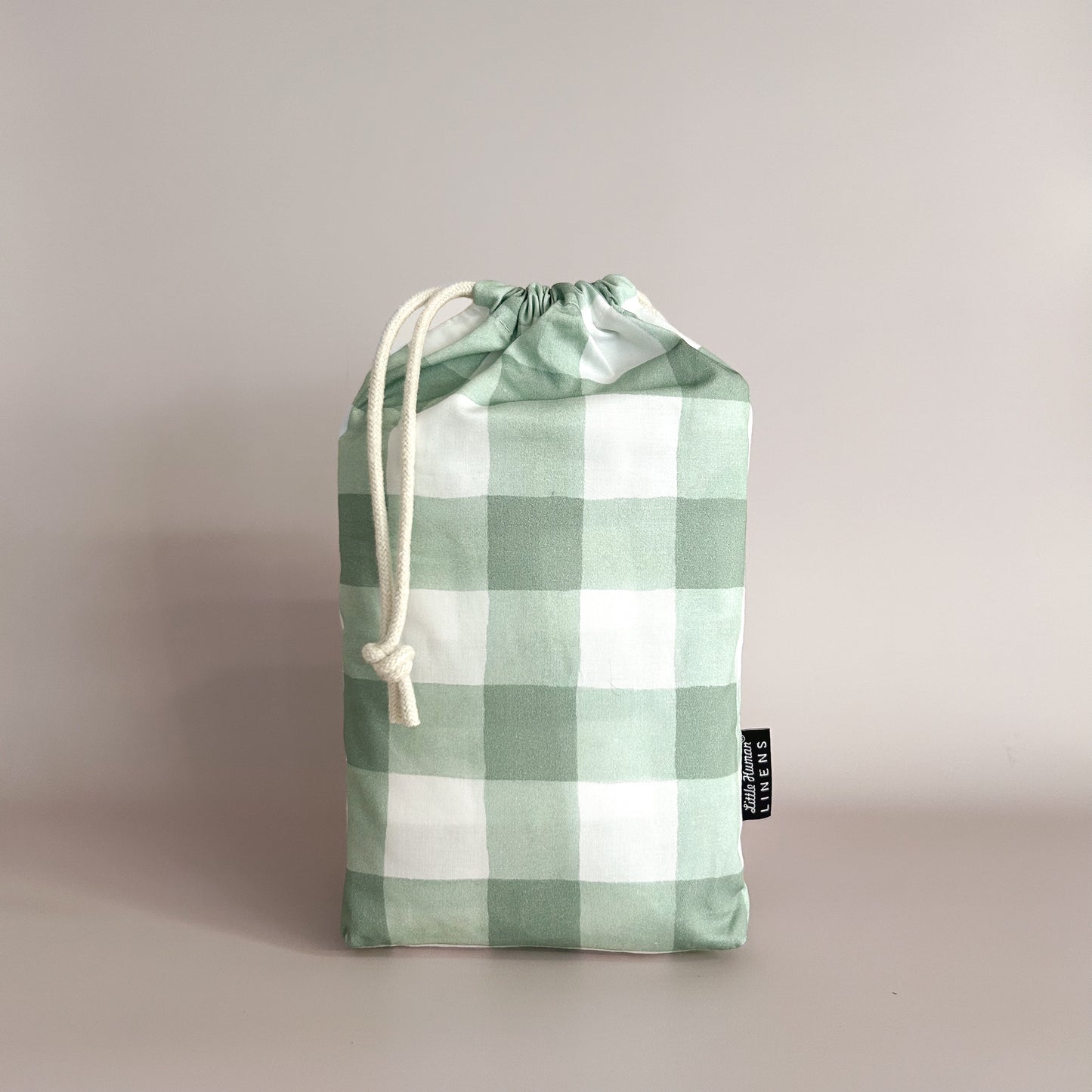 Little Human Linens Green Gingham co-sleeper waterproof fitted sheet in branded reusable packaging bag