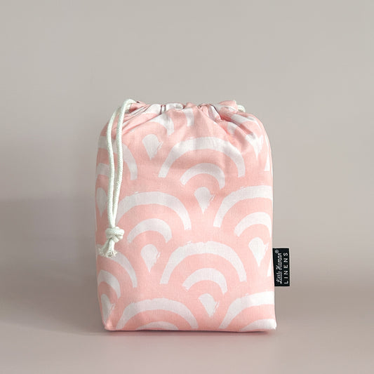 Little Human Linens Peach Rainbows standard co-sleeper waterproof fitted sheet in branded reusable packaging bag