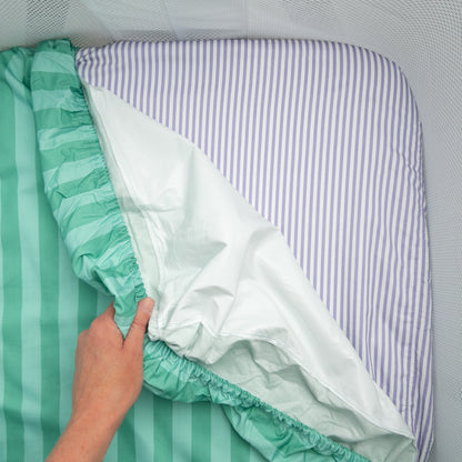 Little Human Linens Mint Candy co-sleeper fitted sheet pulled back to reveal the waterproof layer underneath