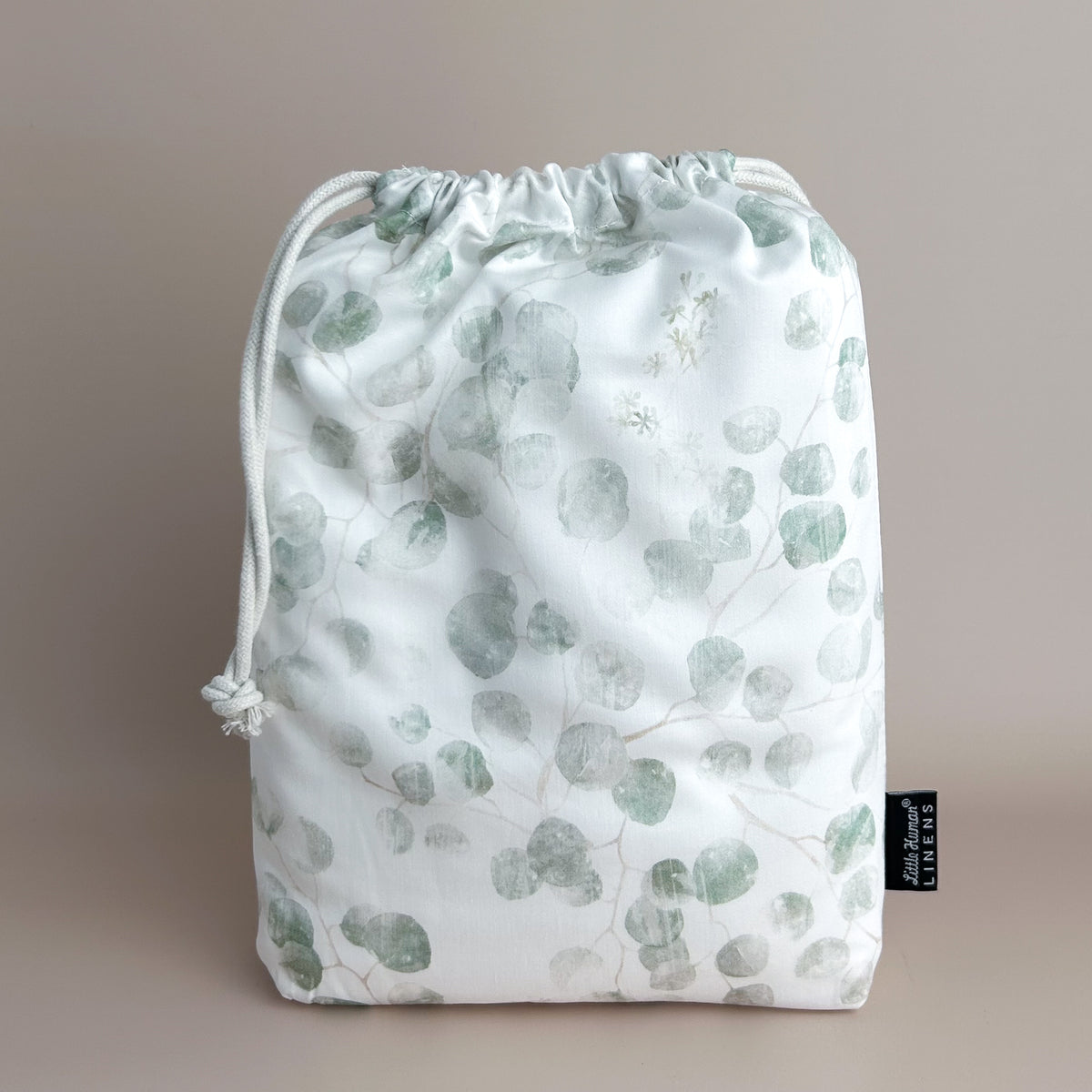 Little Human Linens Eucalyptus european cot waterproof fitted sheet in branded reusable packaging bag