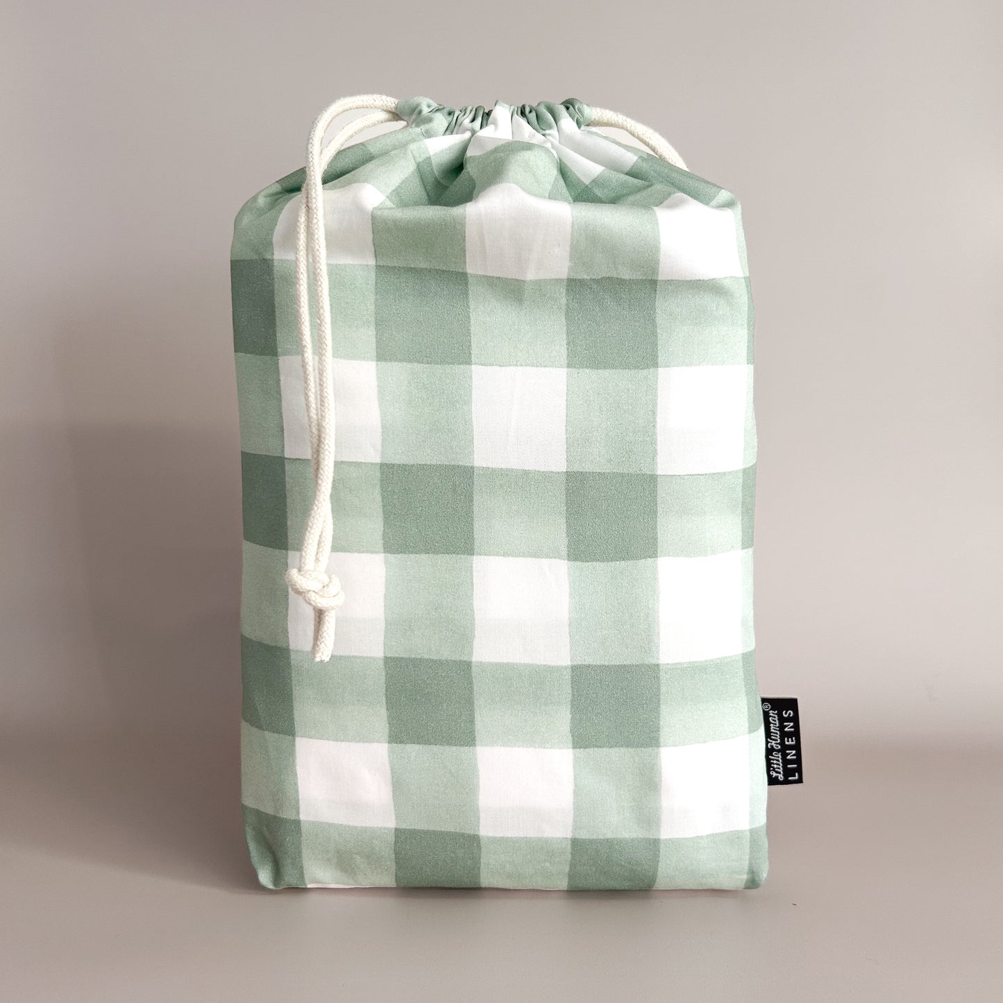Little Human Linens Green Gingham european cot waterproof fitted sheet in branded reusable packaging bag