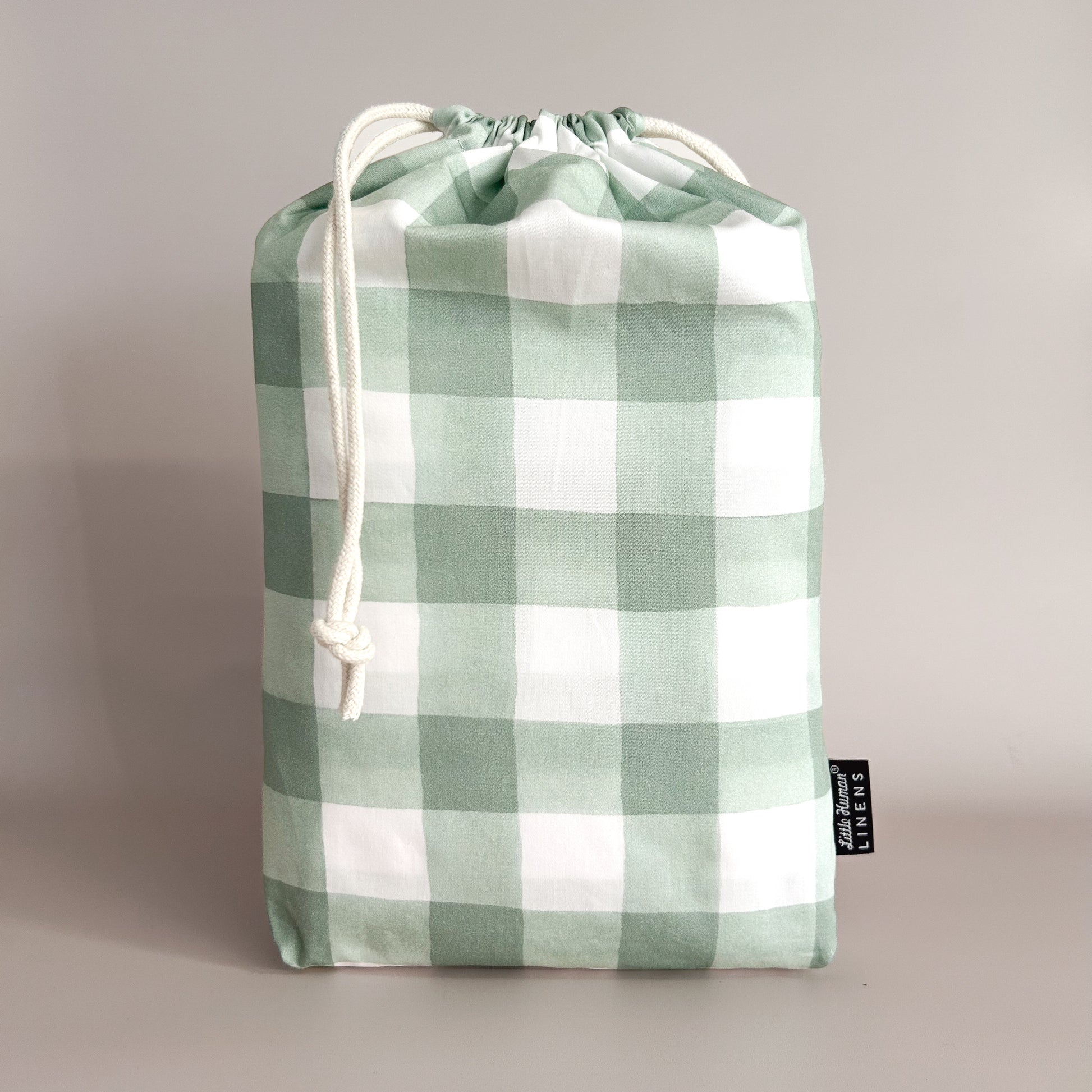 Little Human Linens Green Gingham european cot waterproof fitted sheet in branded reusable packaging bag