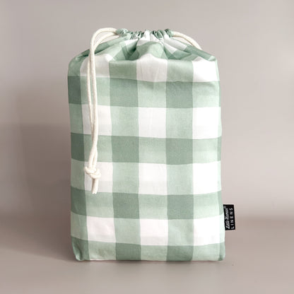 Little Human Linens Green Gingham european cot waterproof fitted sheet in branded reusable packaging bag