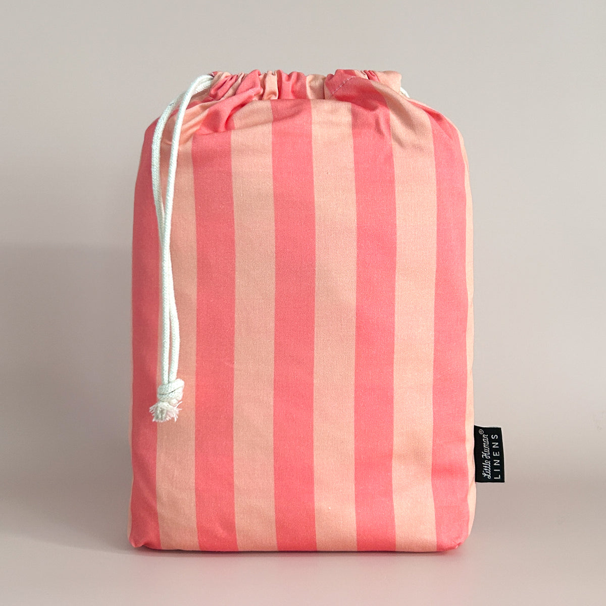 Little Human Linens Peach Candy european cot waterproof fitted sheet in branded reusable packaging bag
