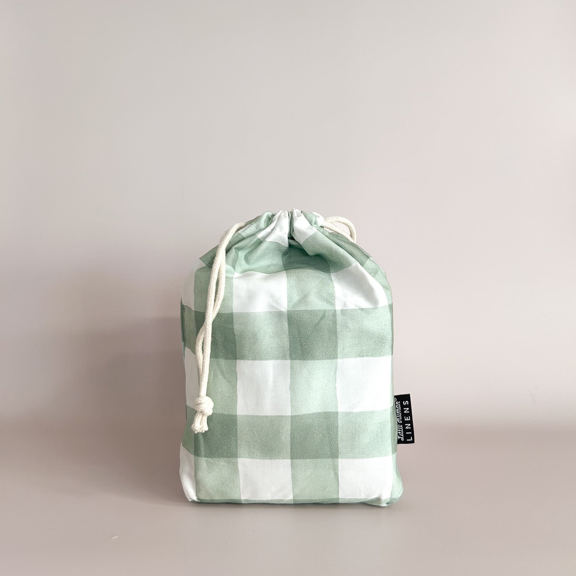 Little Human Linens Green Gingham small bassinet waterproof fitted sheet in branded reusable packaging bag
