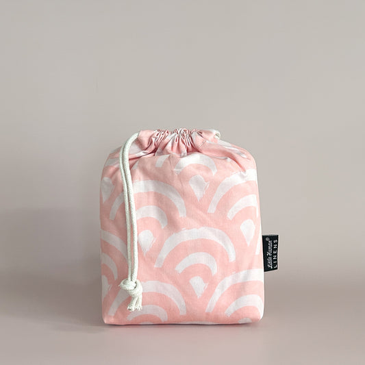 Little Human Linens Peach Rainbows small bassinet waterproof fitted sheet in branded reusable packaging bag