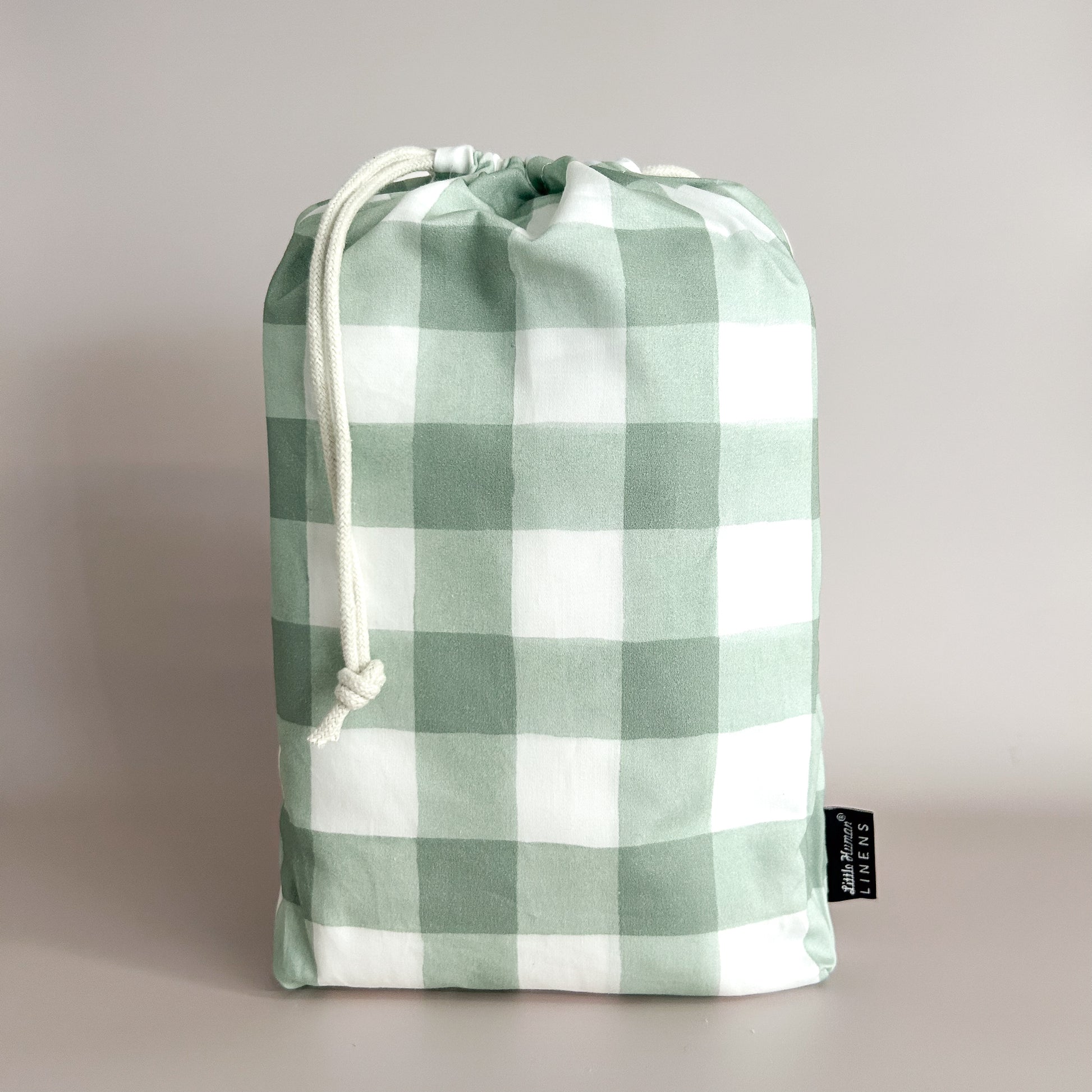 Little Human Linens Green Gingham standard cot waterproof fitted sheet in branded reusable packaging bag