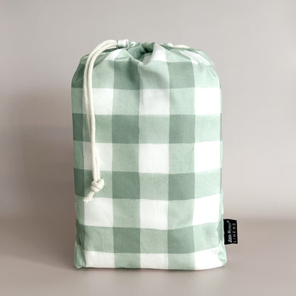 Little Human Linens Green Gingham standard cot waterproof fitted sheet in branded reusable packaging bag