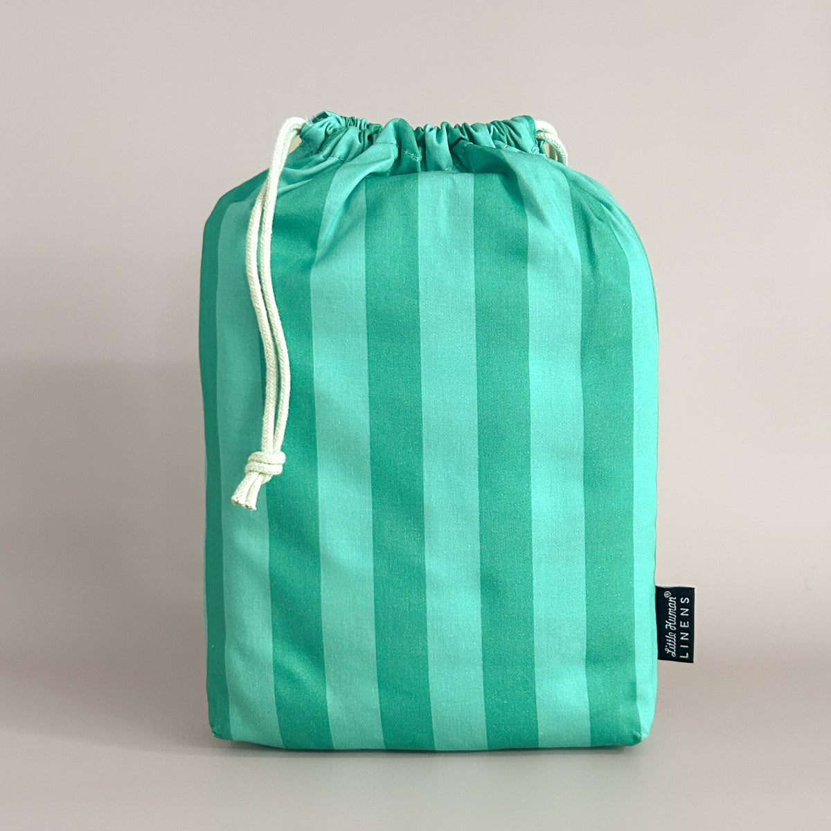 Little Human Linens Mint Candy standard cot waterproof fitted sheet in branded reusable packaging bag
