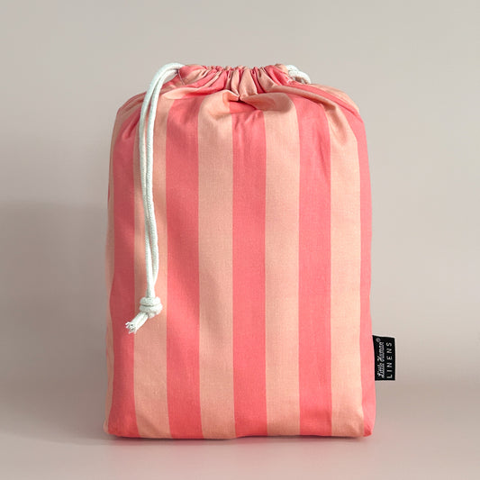 Little Human Linens Peach Candy standard cot waterproof fitted sheet in branded reusable packaging bag