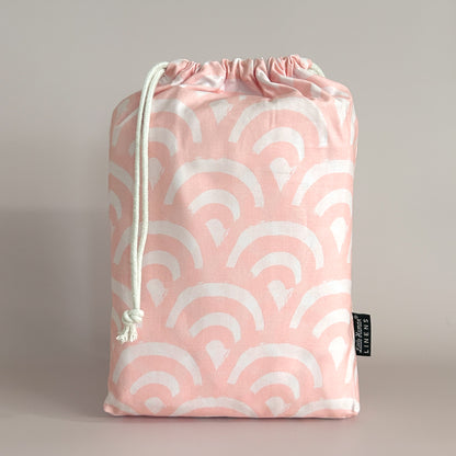 Little Human Linens Peach Rainbows standard cot waterproof fitted sheet in branded reusable packaging bag