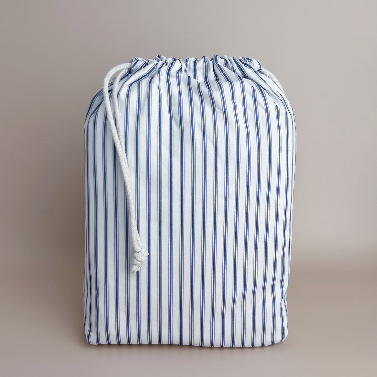 Little Human Linens Navy Ticking standard cot waterproof fitted sheet in branded reusable packaging bag