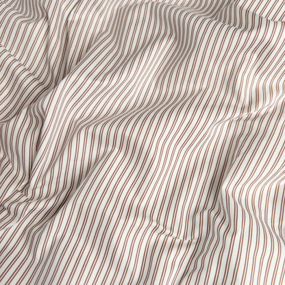 Close-up of mocha pinstripe organic cotton waterproof fabric used in Little Human Linens fitted sheet, showing soft textured weave