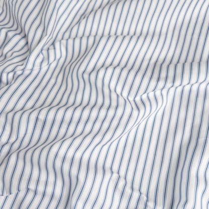 Close-up of navy ticking organic cotton waterproof fabric used in Little Human Linens fitted sheet, showing soft textured weave