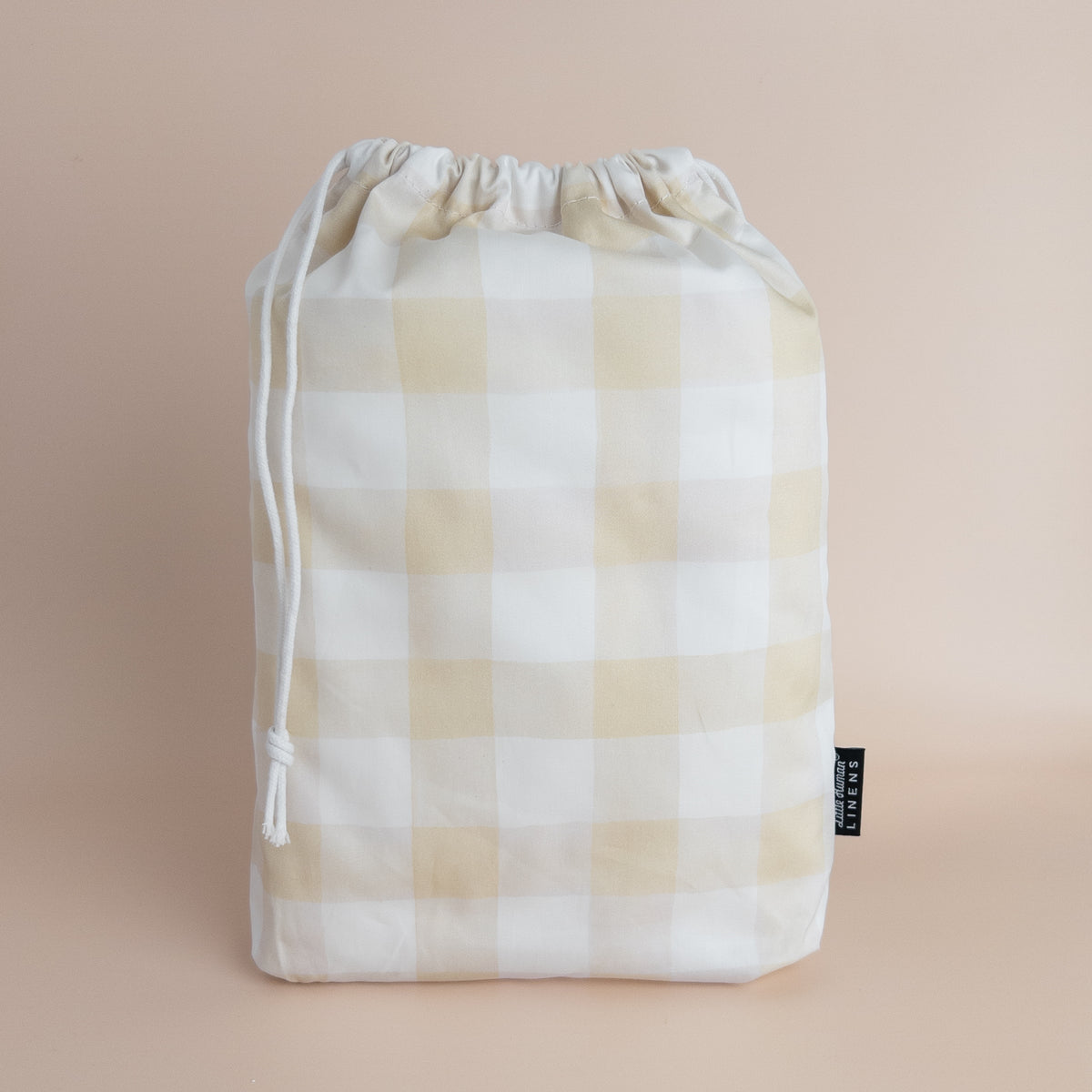 Little Human Linens Latte Gingham standard cot waterproof fitted sheet in branded reusable packaging bag
